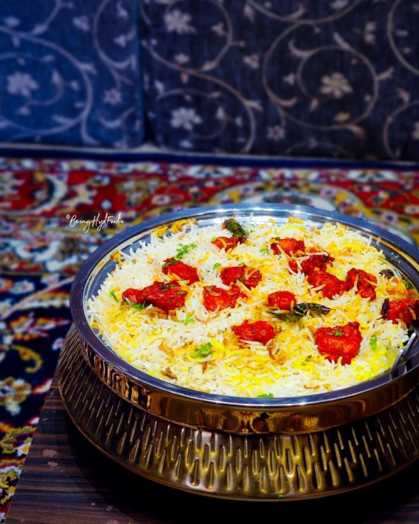 A bowl of flavoured rice with spiced meat dotted on top