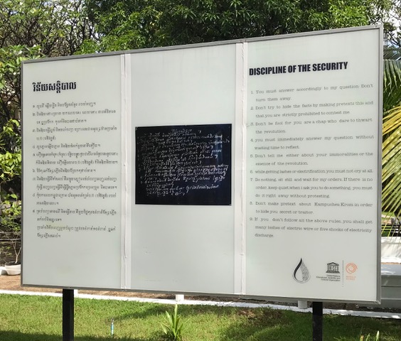 A display board showing prisoner interrogation rules during the Khmer Rouge regime.